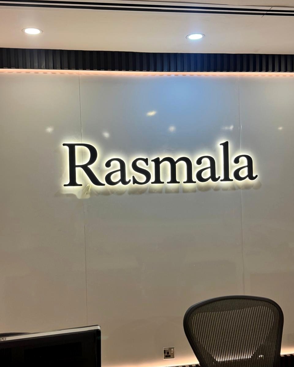 Backlit 3D logo letters on an office reception wall in Dubai